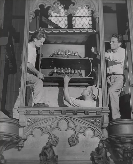 organ being dismantled by two men