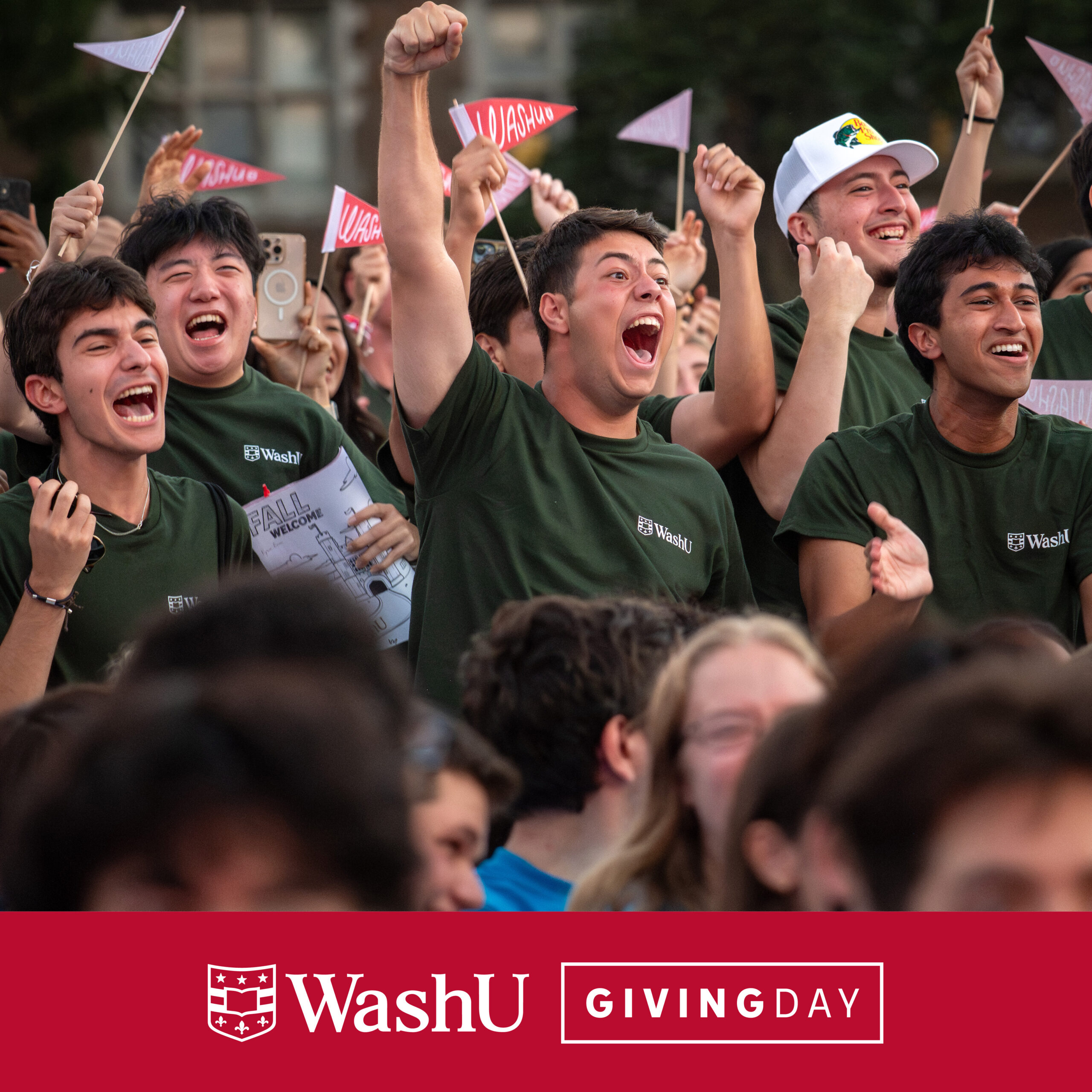 Social media graphic promoting WashU Giving Day featuring a group of first-year students cheering at Convocation wearing green WashU t-shirts
