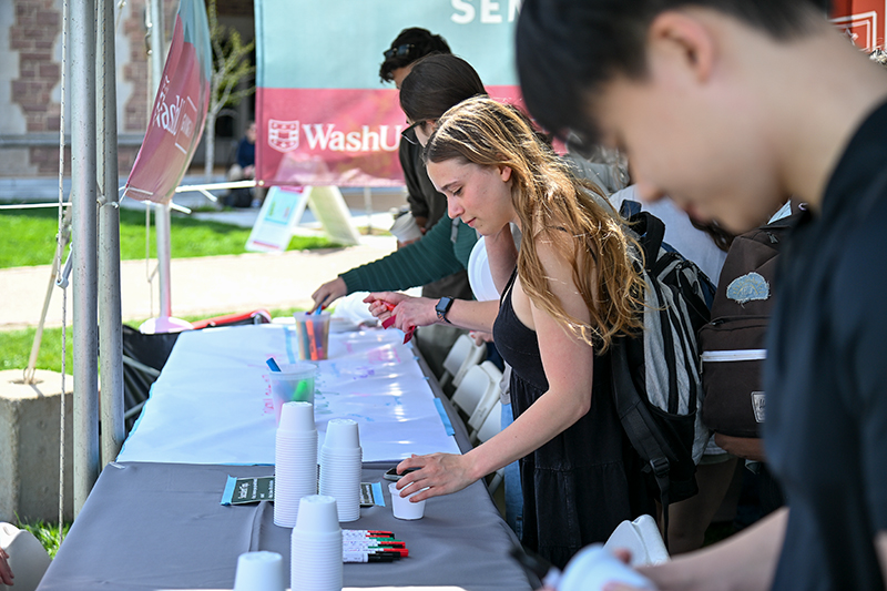 student getting ready to write a sign