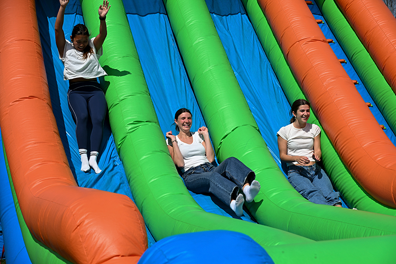 students going down slide at Dr. G's Funhouse