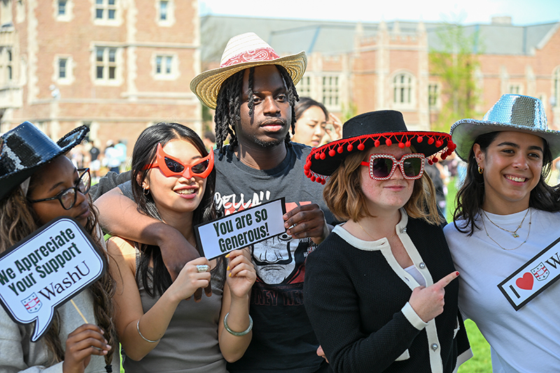 students pose with signs