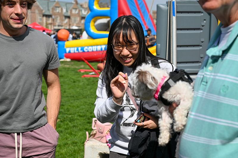 student saying hi to a dog