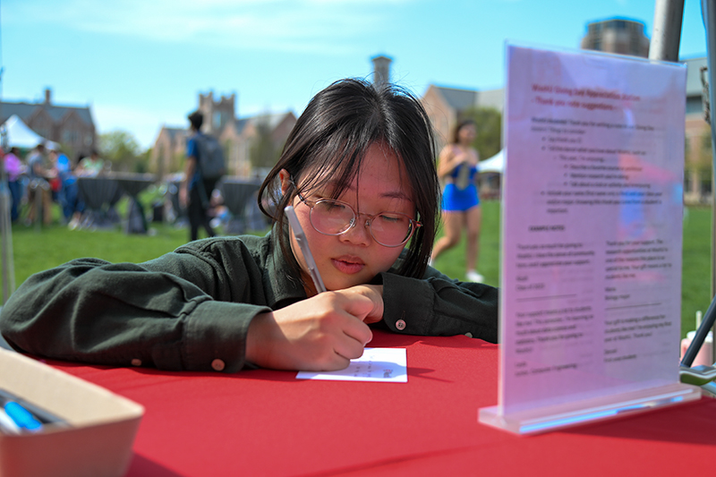 student writing a note
