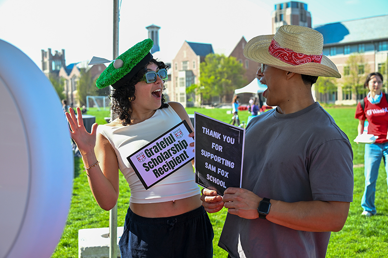 two students wearing festive hats