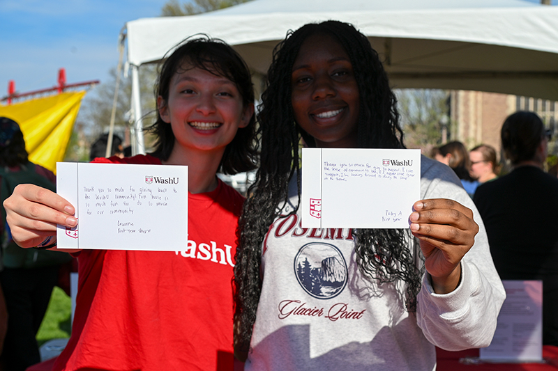 two students holding their thank you note