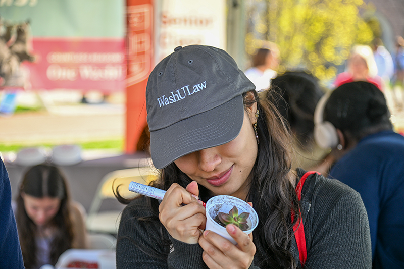 student writing on the outside of cup 