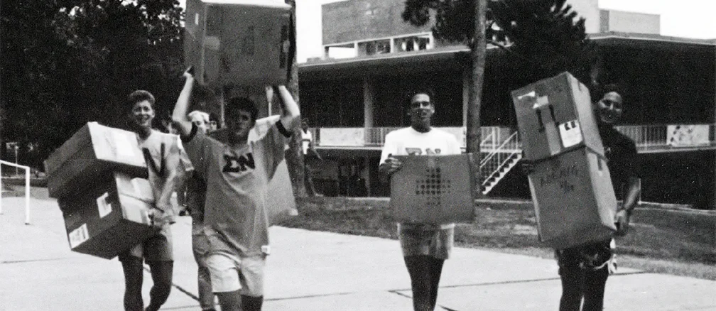 students carry boxes during move in day in 1986