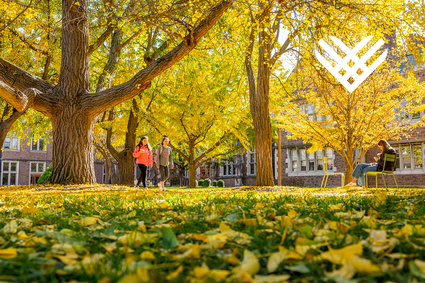students walking on campus with Giving Tuesday logo in top right
